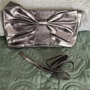 Metallic, silver, oversized clutch with detachable strap